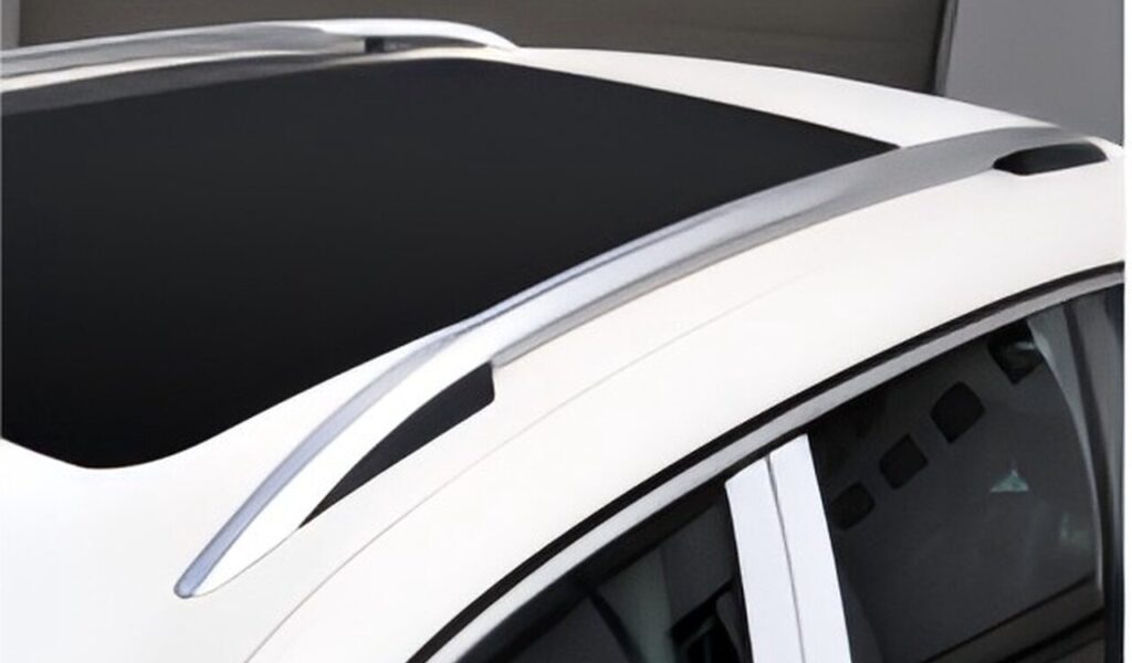 Silver roof rails on top of a white car with a black sunroof.